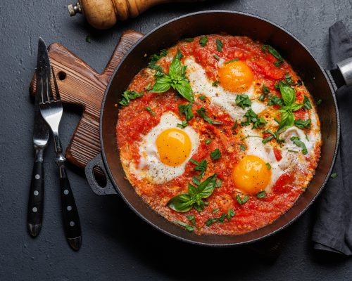 Delicious shakshuka breakfast in a pan. Flat lay